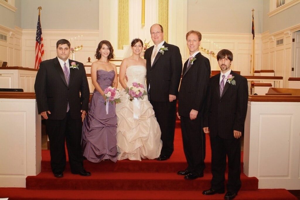 Karl and Nancy's wedding day. A photo of the wedding party in the church.